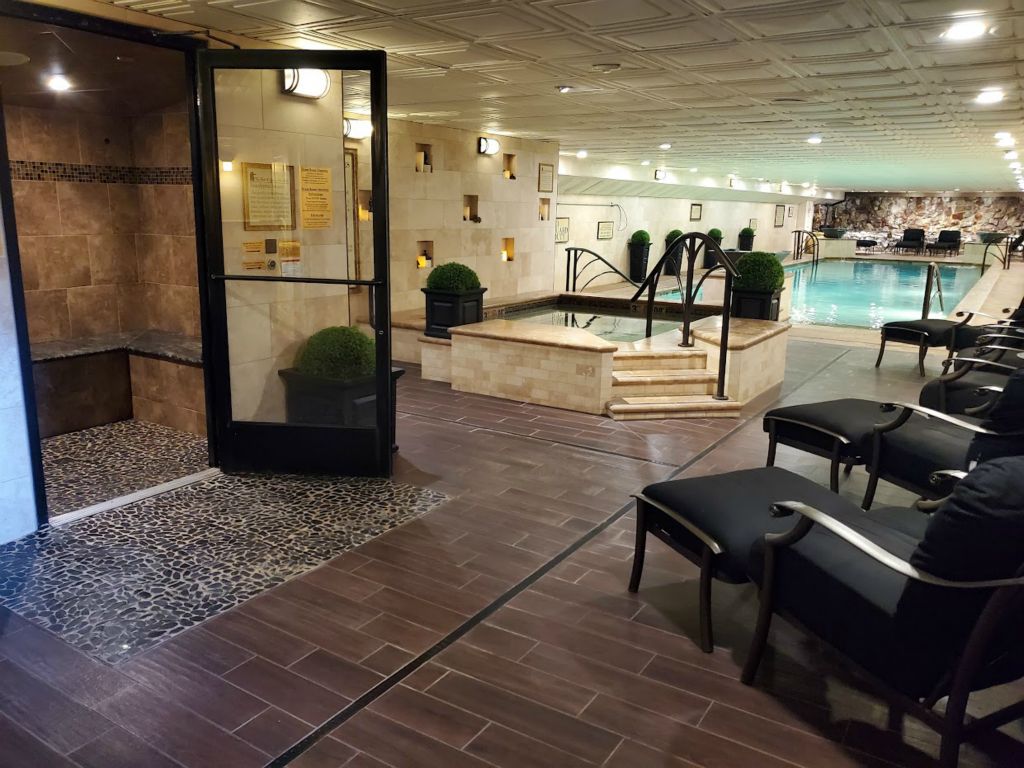 The indoor heated pool behind the glass door